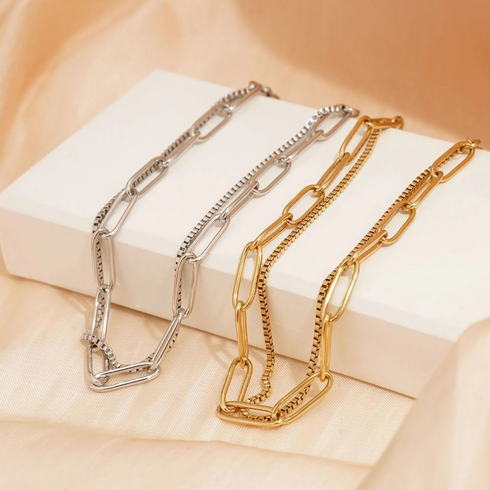 Women's double layer twin titanium steel bracelet in a geometric cold style, shown in gold and silver colours.