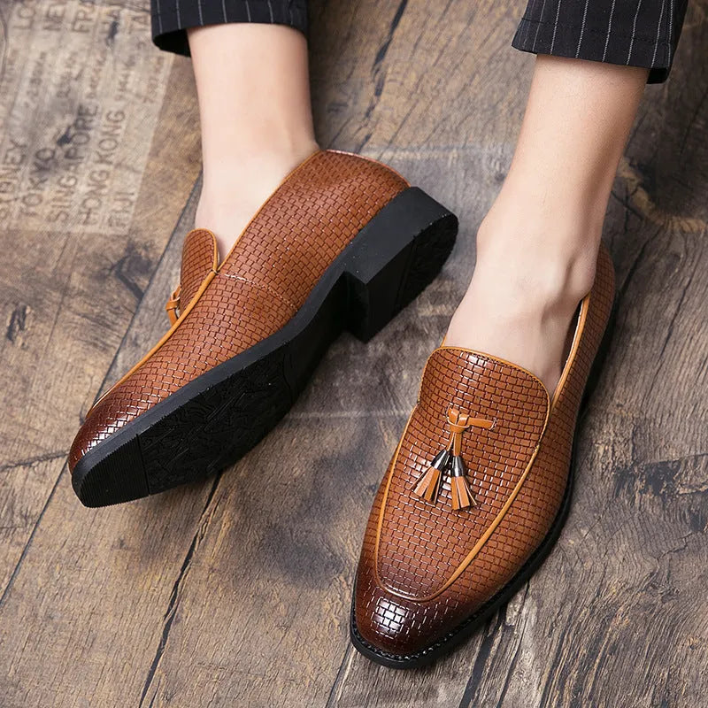 Men's black pointed slip-on shoes with a tassel detail on the front, made from artificial PU.