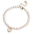 Women's freshwater pearl bracelet with fan-shaped design on wrist, showing elastic and chain fastening options.