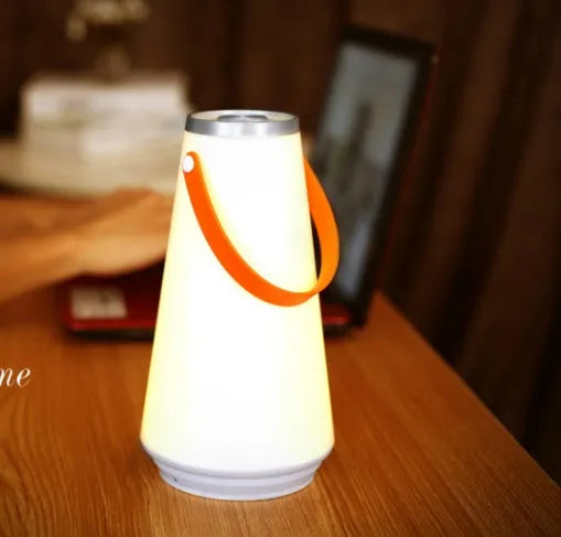 White rechargeable LED bedside night light with touch controls showing compact 12cm square design