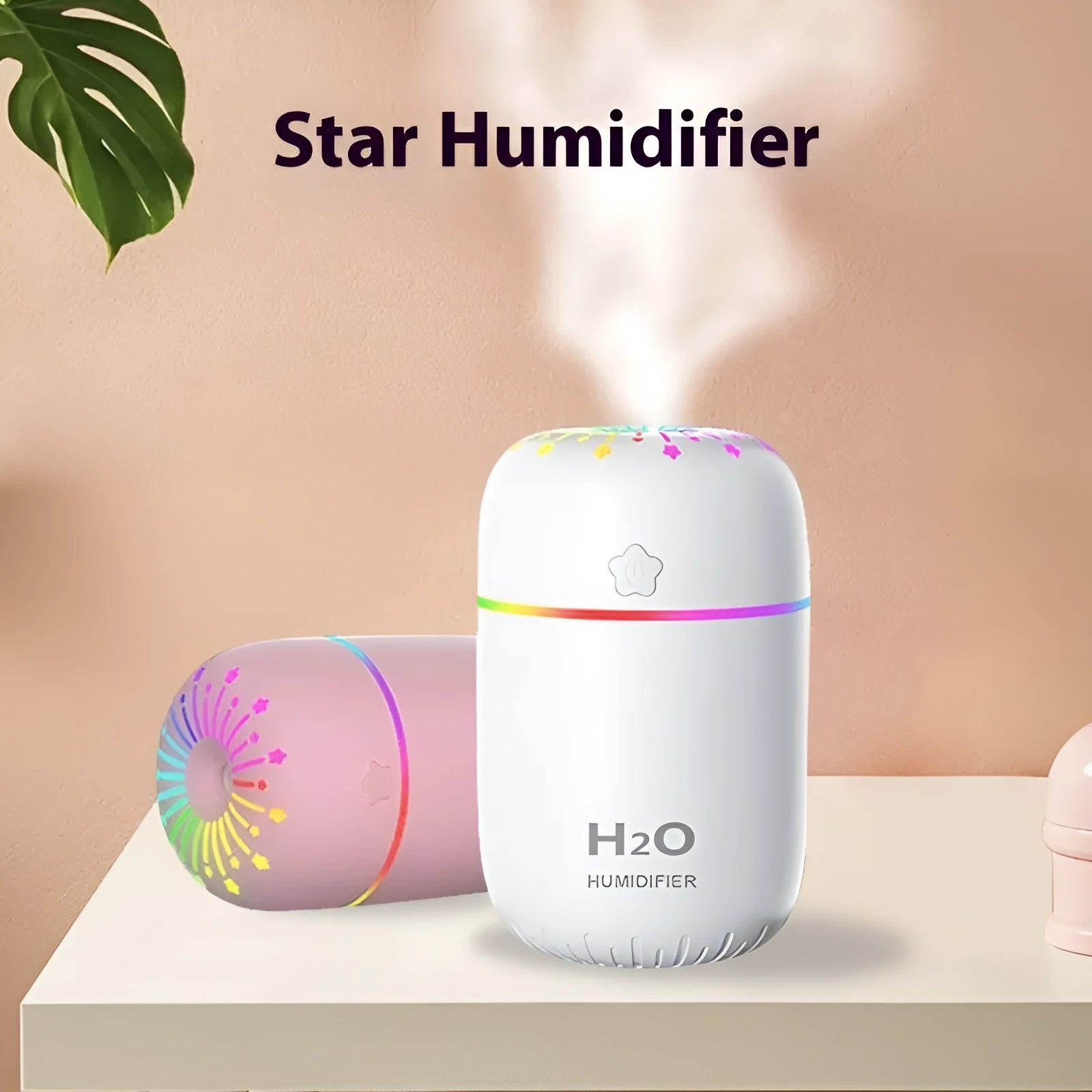 White USB mini humidifier with water tank on desk next to laptop