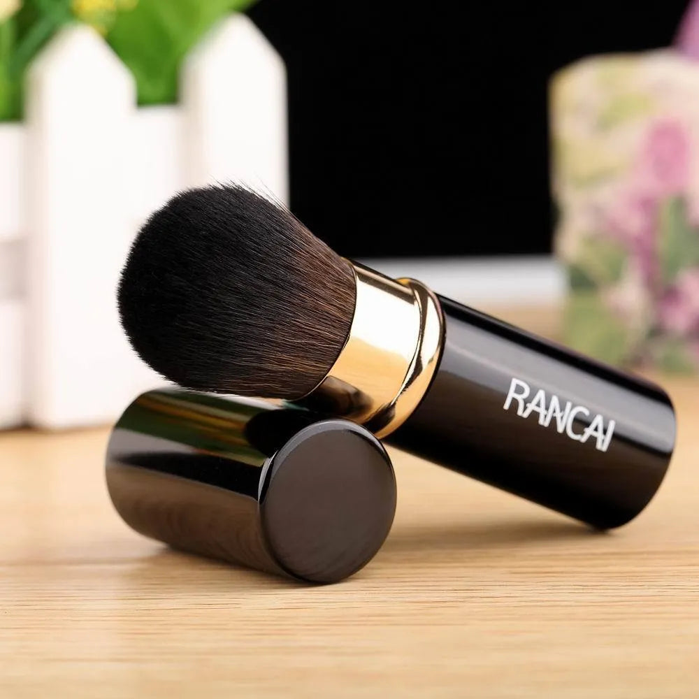 Single mini retractable makeup brush with aluminium tube and fibre wool bristles, 9cm long, available in black or red