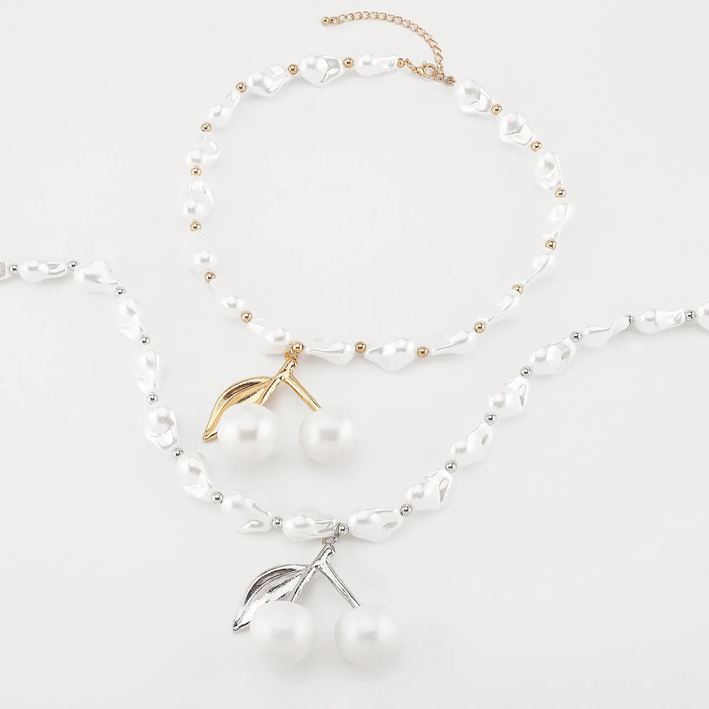 Women's adjustable cherry necklace with geometric fruit pendant on imitation pearl chain in gold or white K colour