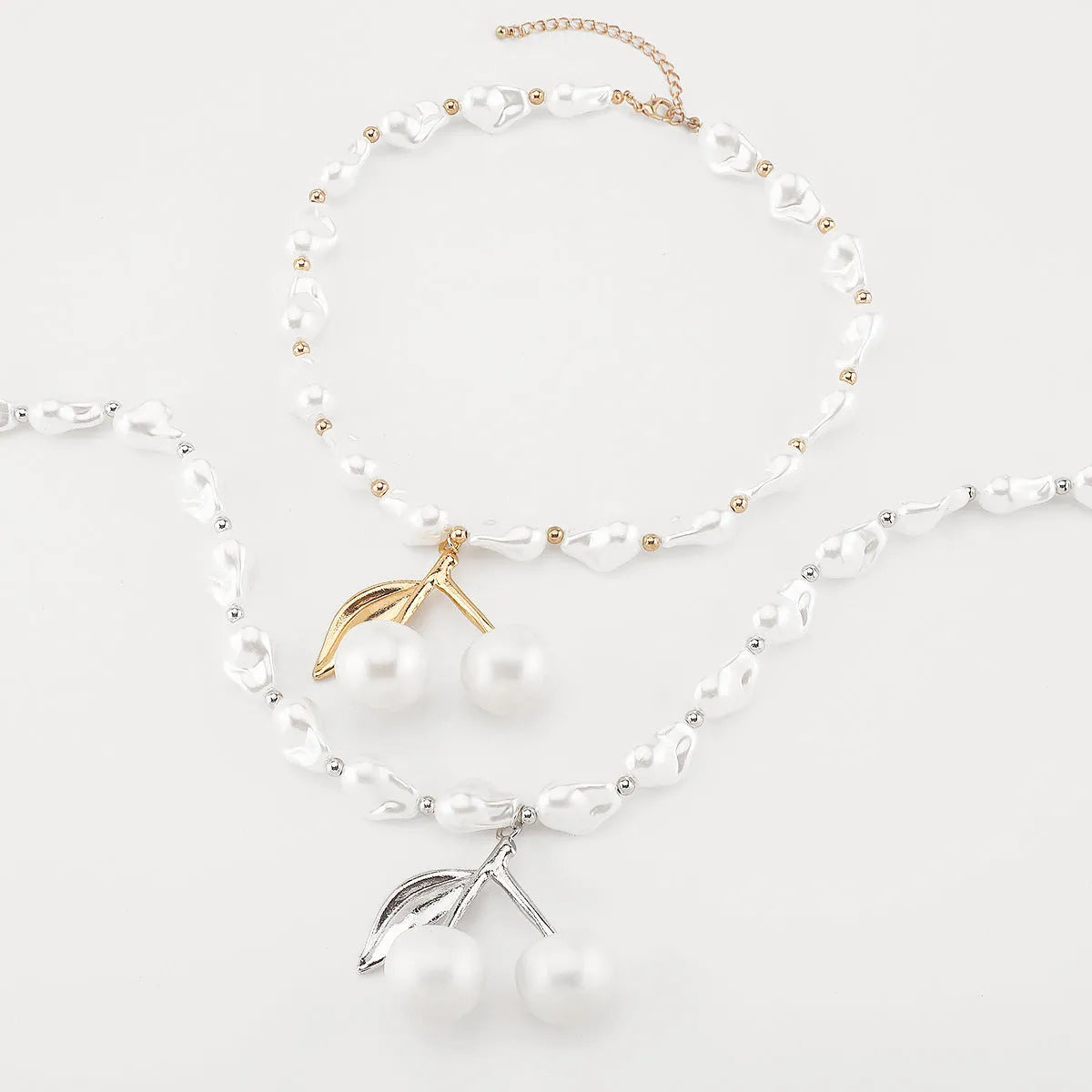 Women's adjustable cherry necklace with geometric fruit pendant on imitation pearl chain in gold or white K colour