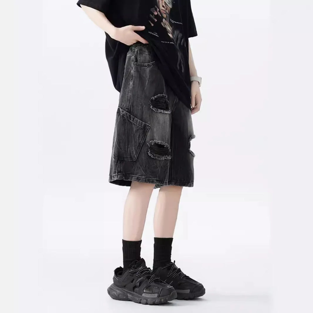 Man's washed blue denim shorts with ripped details and a loose, retro fit.