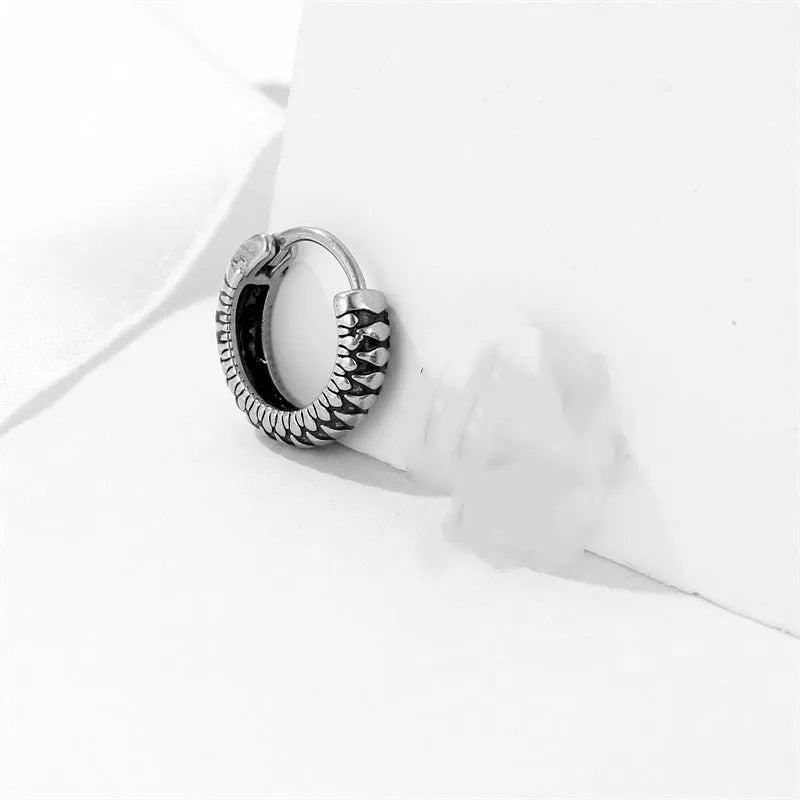 Silver geometric striped earrings with a circular centre, made from polished stainless steel.