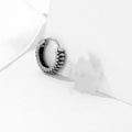 Silver geometric striped earrings with a circular centre, made from polished stainless steel.