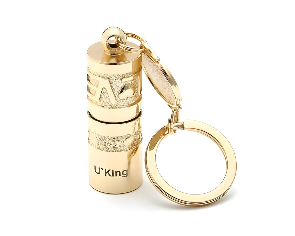 Gold-coloured waterproof mini LED keychain flashlight with zinc alloy housing on a key ring.