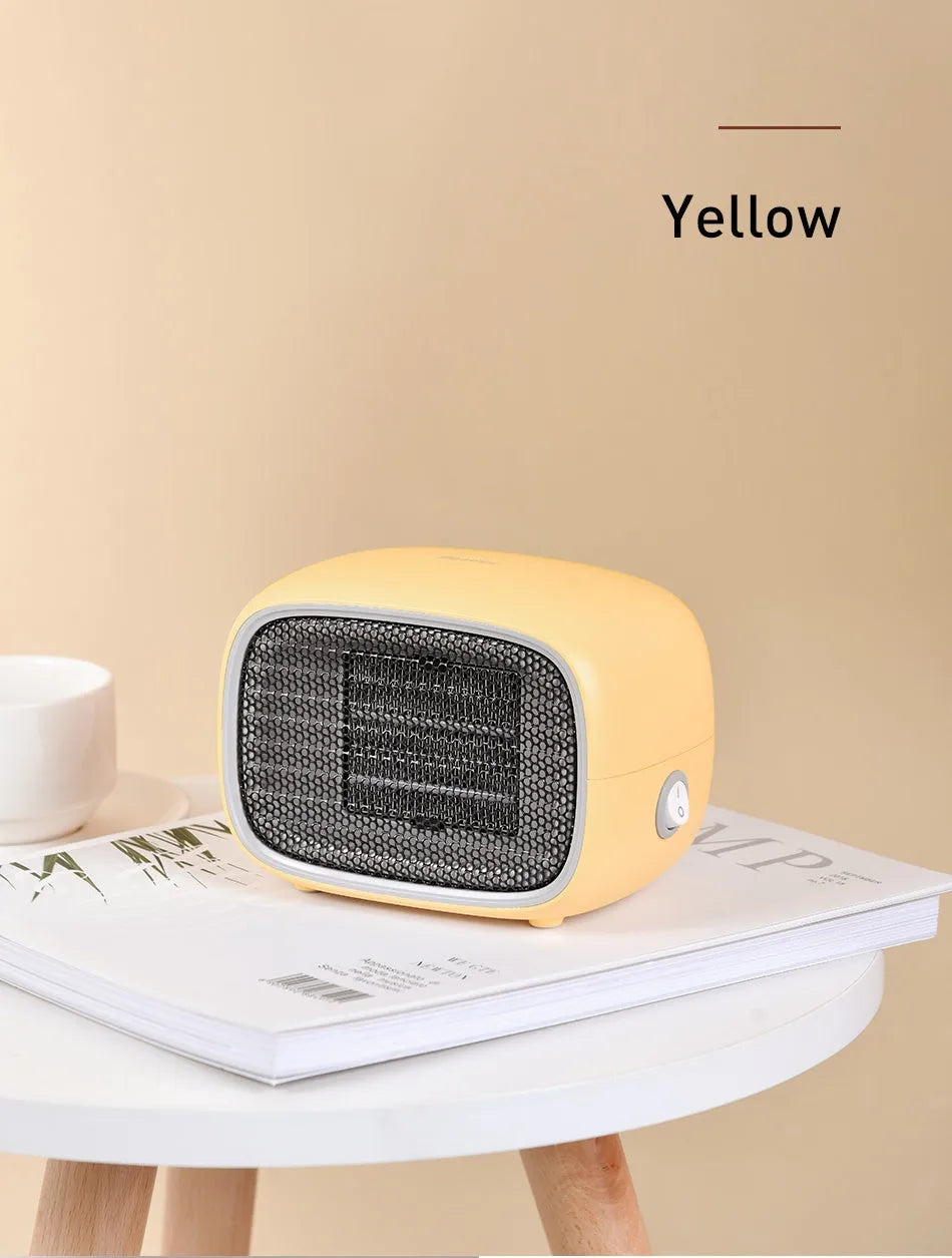 Compact green mini ceramic heater with metal mesh grille on a desk