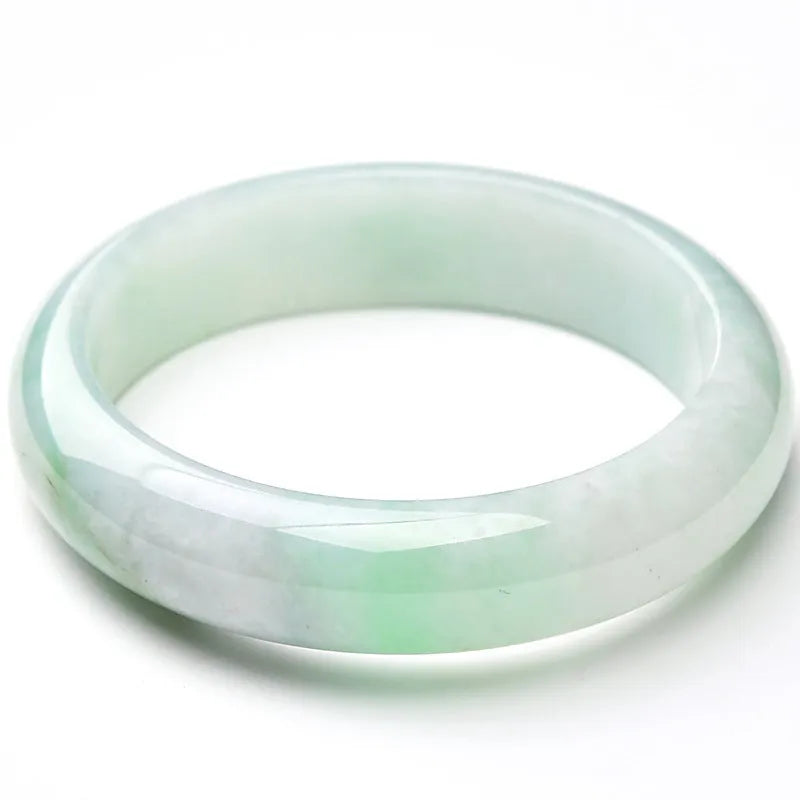 Light green jade bracelet with smooth surface showing natural stone texture