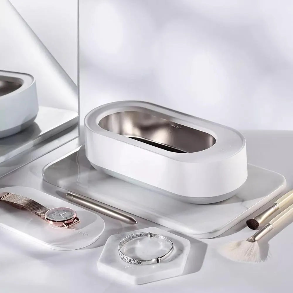 White portable ultrasonic cleaning machine with stainless steel tank for jewellery and glasses.
