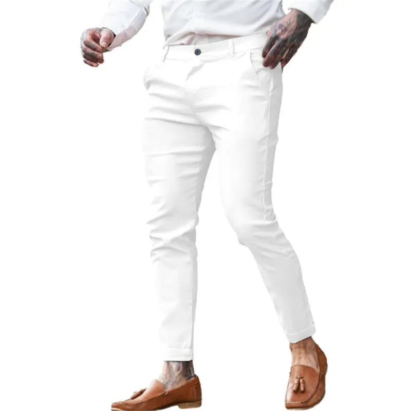 Men's slim-fit pencil trousers in high elasticity cotton twill fabric on a grey background.
