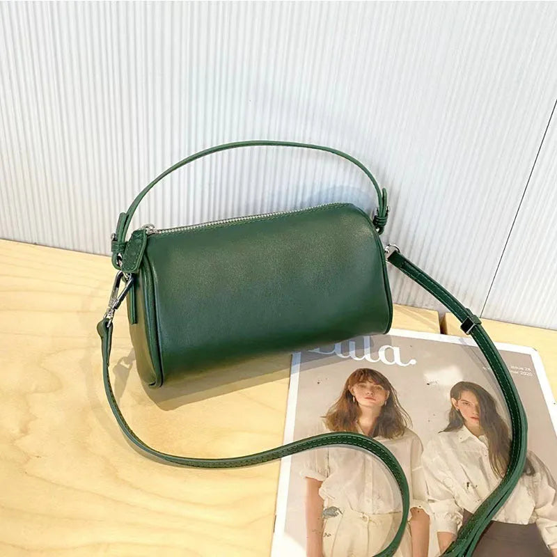 Genuine leather crossbody phone bag in cylindrical shape with single shoulder strap