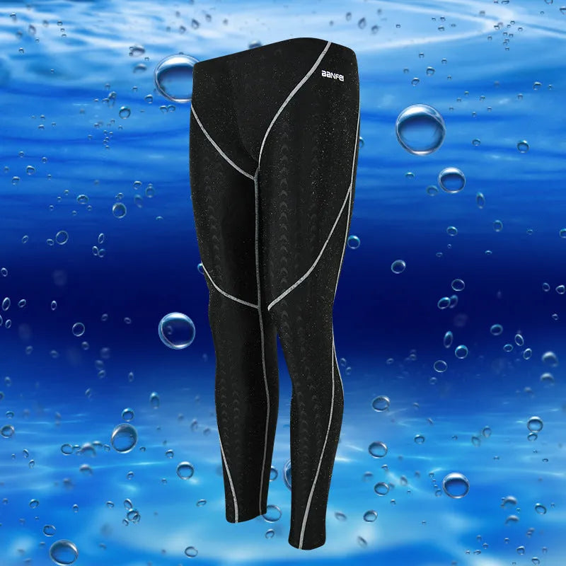Men's black and grey line nylon cropped swimming trunks laid flat.