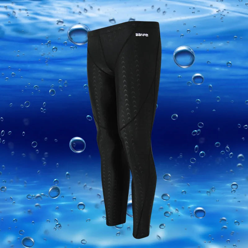 Men's black and grey line nylon cropped swimming trunks laid flat.