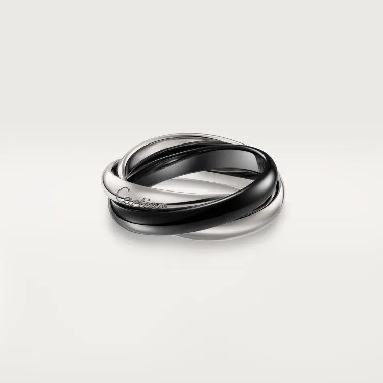 Set of three geometric U-shaped silver couple rings with diamond accents on a grey background.