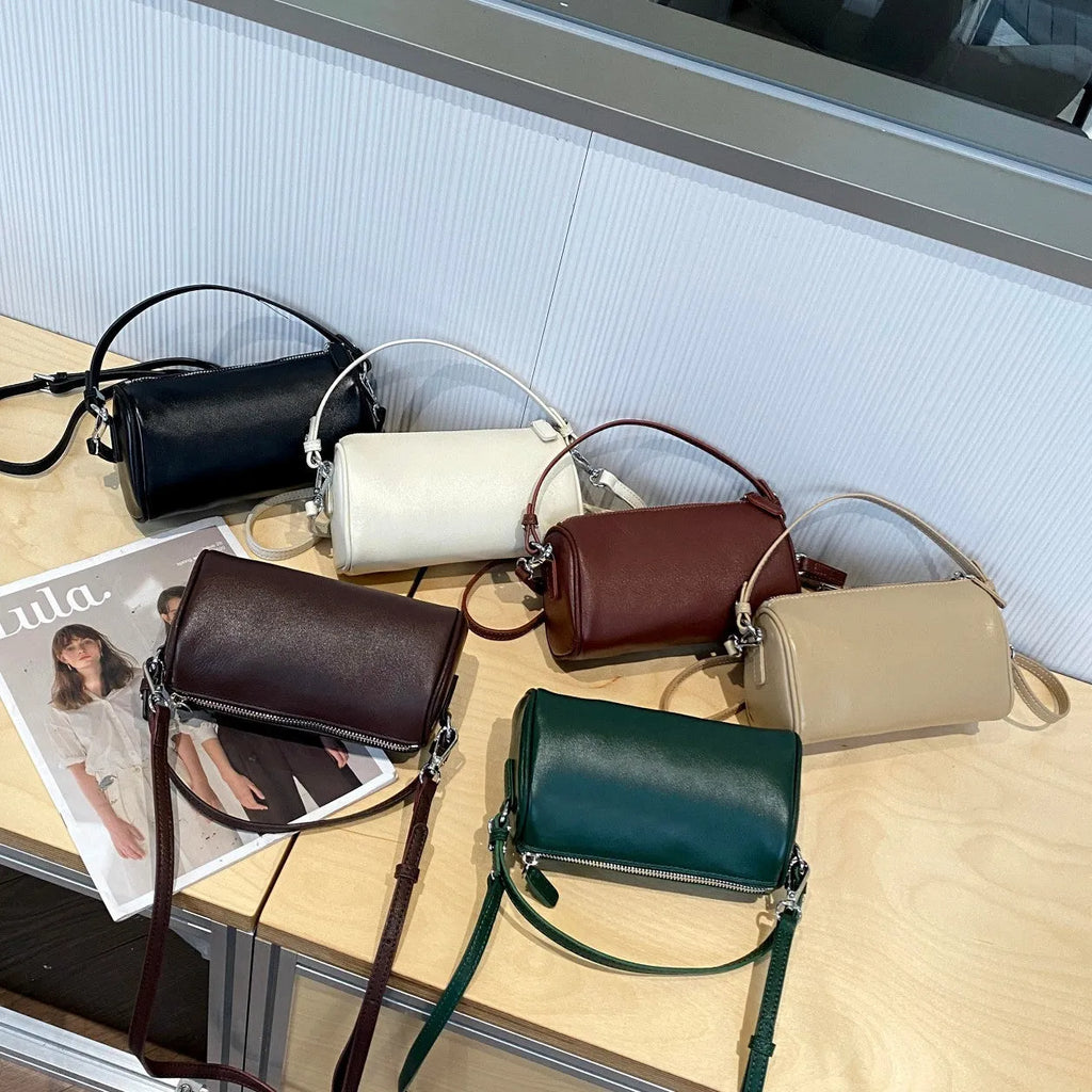 Genuine leather crossbody phone bag in cylindrical shape with single shoulder strap