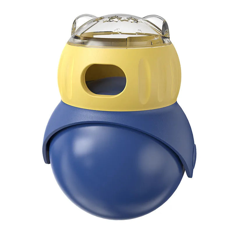 Yellow and blue plastic tumbler-style cat feeder puzzle toy on a floor.