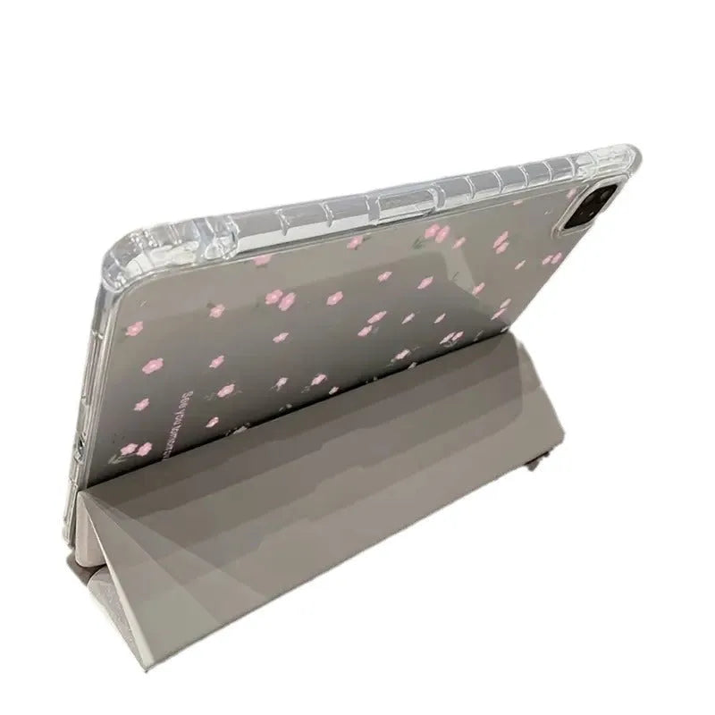 Transparent floral tri-fold iPad case with magnetic stand, showing cartoon print on clear PC hard shell.