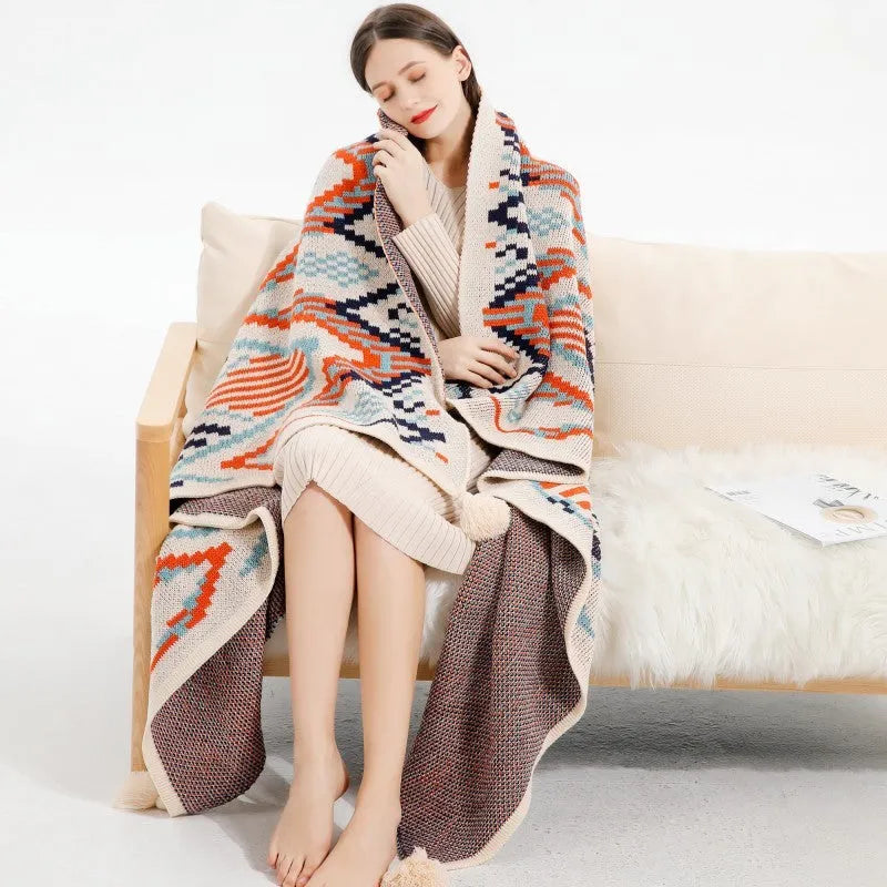 Acrylic sofa cover blanket with tassel trim in beige and orange colour.
