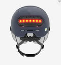 Cycling helmet with built-in red LED tail light on the back, shown in two style options.