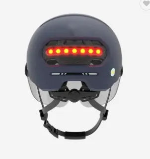 Cycling helmet with built-in red LED tail light on the back, shown in two style options.