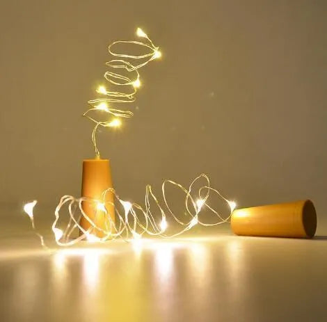 Silver copper wire LED string lights wrapped around wine bottle with 20 white LEDs