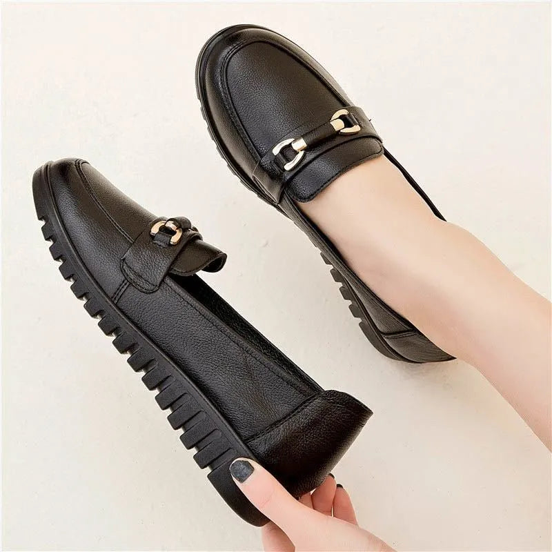 Black women's casual slip-on pumps with a round toe, low heel, and metallic detail.