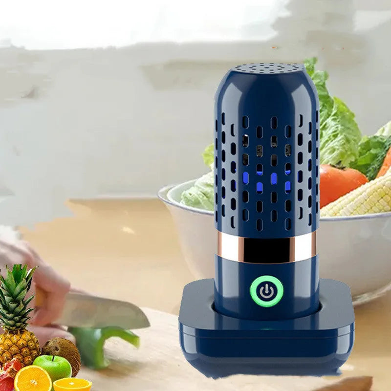 Blue capsule fruit and vegetable cleaner on a kitchen surface with USB charger