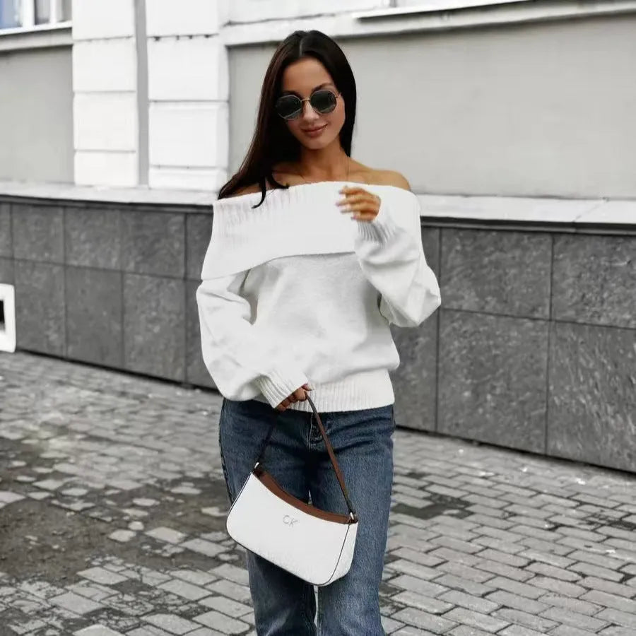 Grey off-the-shoulder sweater with a strapless neckline and a raised 3D pattern across the front.