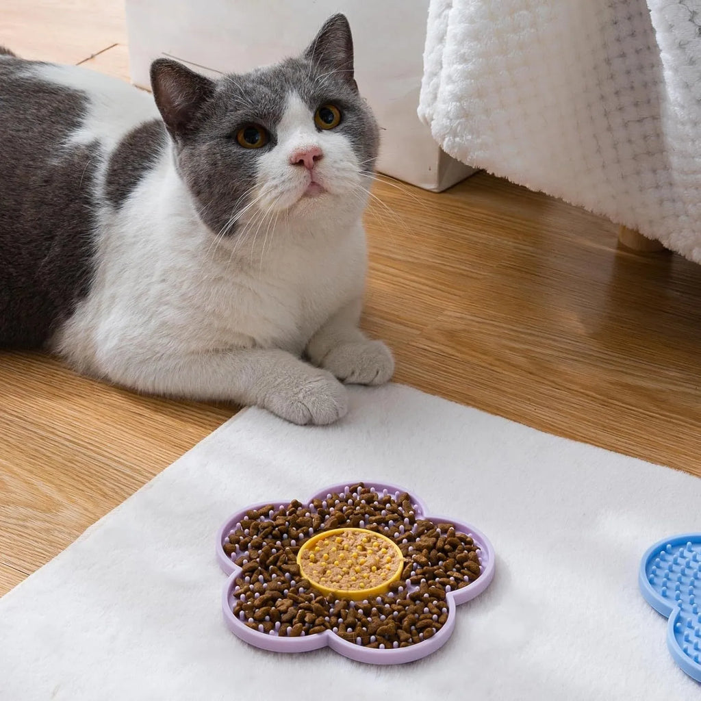 Flower-shaped silicone pet lick mat in assorted colours with suction cups on the base.