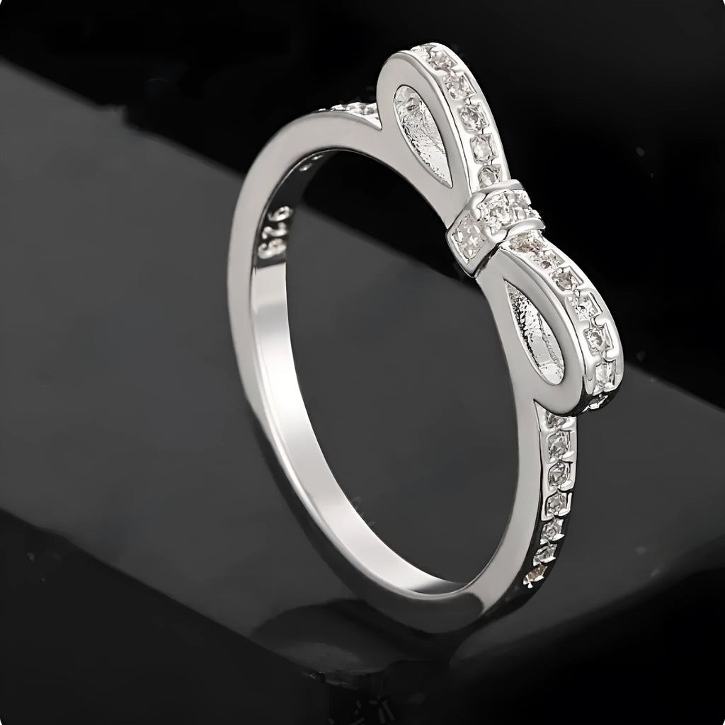 Silver couple's ring with bow design and zircon crystal rhinestones on sterling silver band