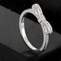 Silver couple's ring with bow design and zircon crystal rhinestones on sterling silver band