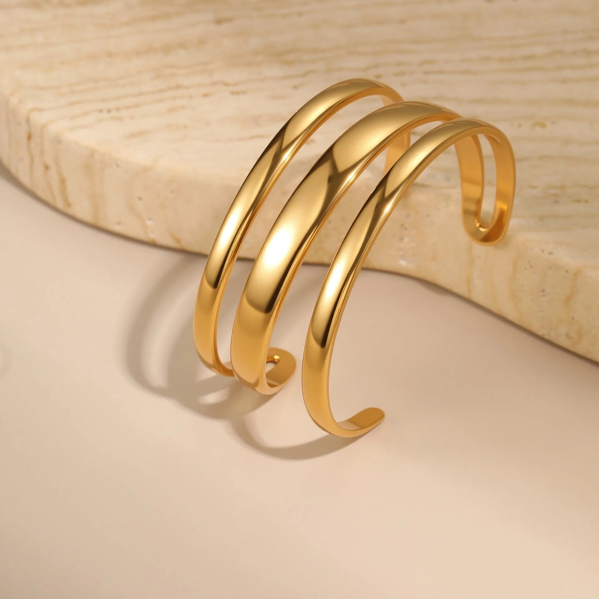 Stainless steel women's bracelet with geometric design and 18K gold electroplating in gold and steel colour options