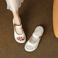 Women's apricot and white soft leather peep toe flat platform sandals with a rubber sole.
