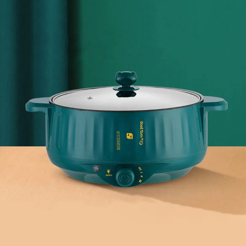 White stainless steel electric hot pot with non-stick interior on a kitchen countertop.