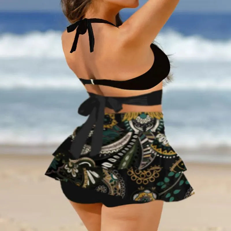 Purple women's bikini with lace-up front and matching high-waisted split skirt.