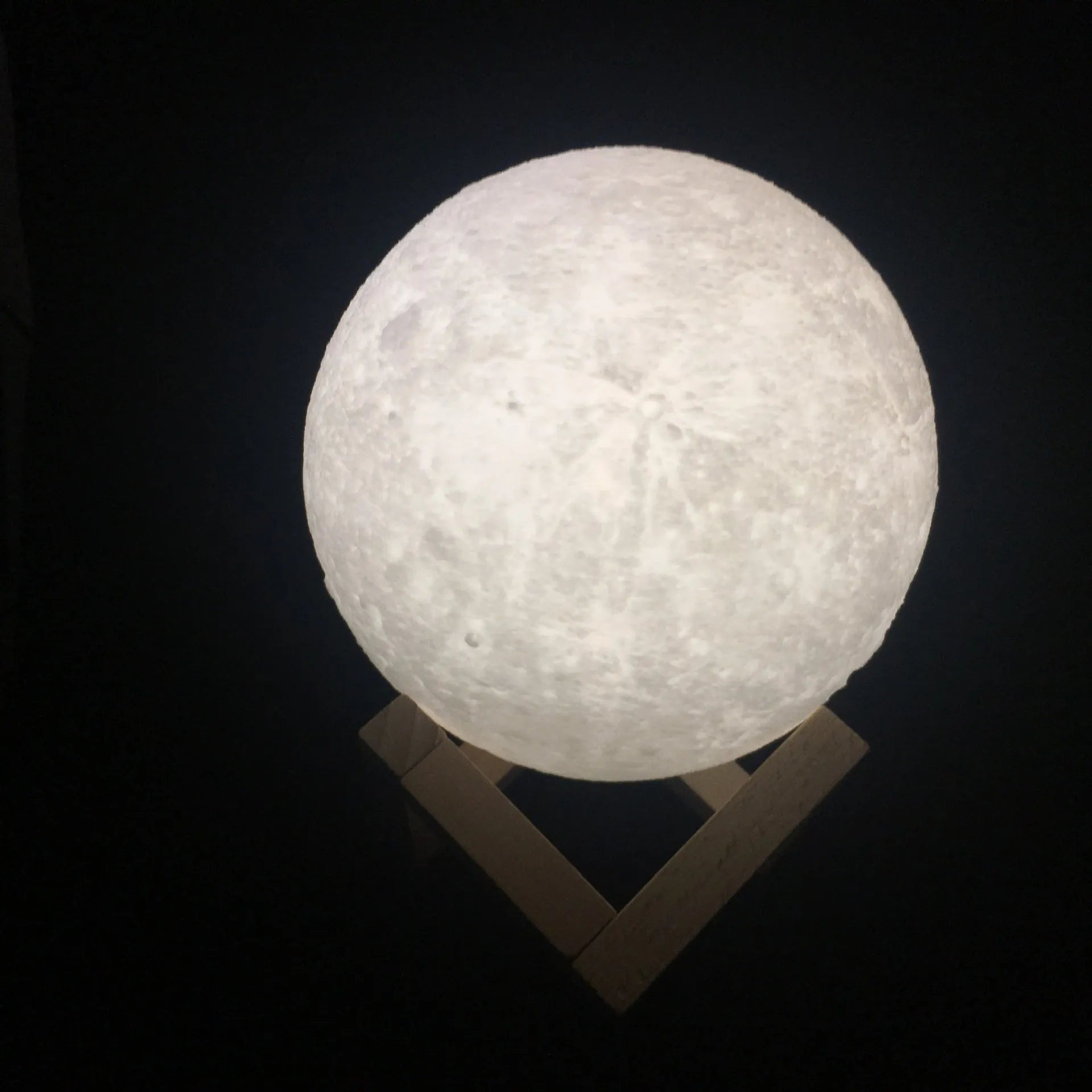 3D printed moon lamp with lunar surface detail on wooden stand, showing touch metal ring at base