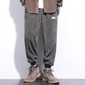 Men's grey ankle-tied sweatpants with a straight leg and non-ironing fabric.
