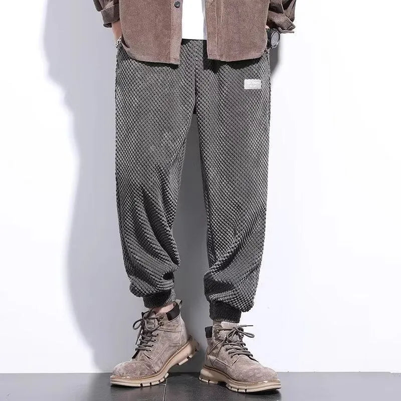 Men's grey ankle-tied sweatpants with a straight leg and non-ironing fabric.