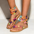 Women's ethnic style beaded petal floral roman sandals with round toe and PU upper.