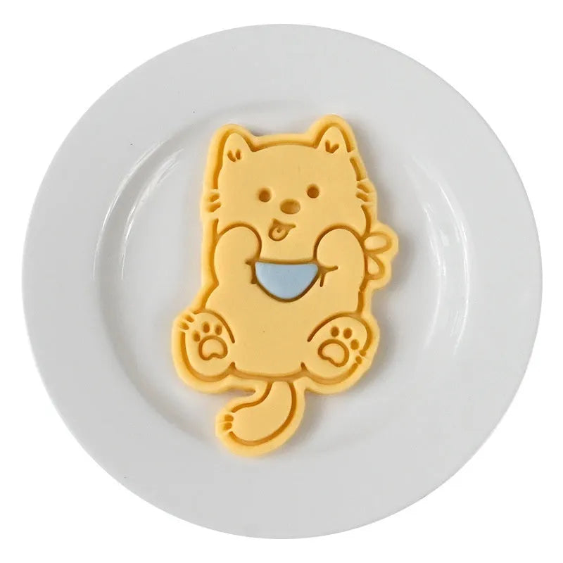 Plastic 3D cartoon puppy biscuit mould showing seven style variations including birthday hat and swimming ring designs