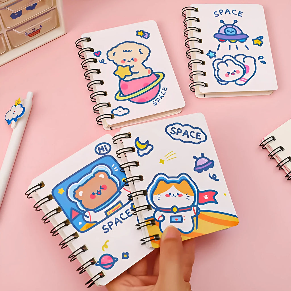 Small astronaut-themed flipper notebook showing one of four cover designs: Astronaut Bear, Planet Teddy, Space Cat, or UFO.