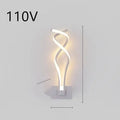 Nordic minimalist LED wall lamp with silicone shade in black finish mounted beside bed