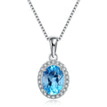 Four-piece sterling silver jewellery set with blue topaz stones: geometric earrings, ring, pendant, and necklace.