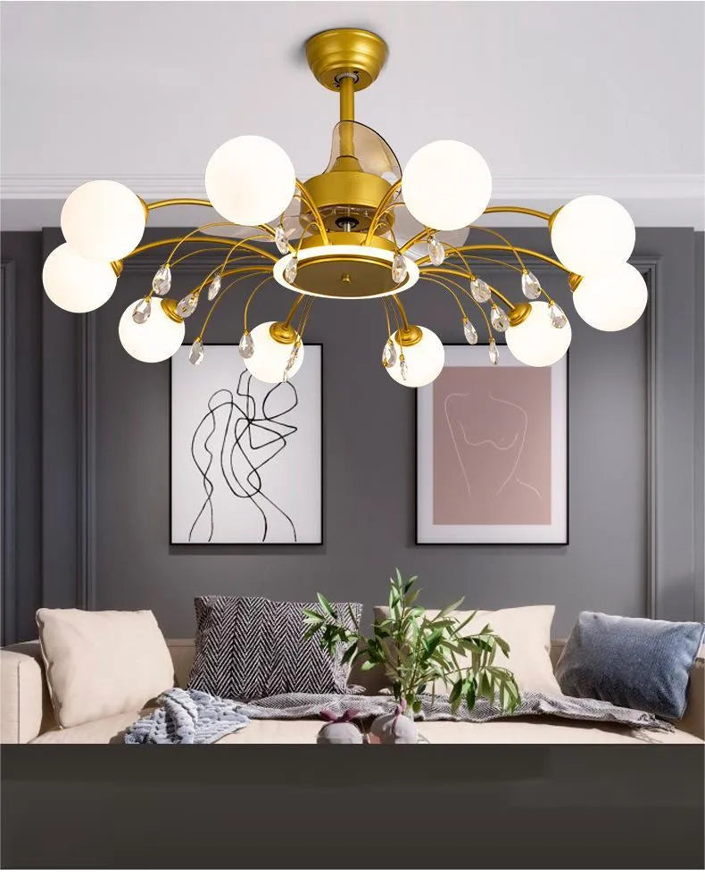 Gold and black ceiling fan lamp with chandelier style lights and metal blades.