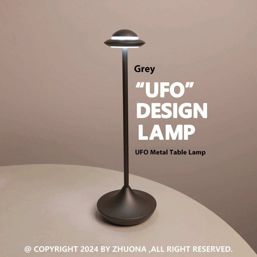 Gold UFO-shaped metal desk lamp with touch controls on creative rechargeable LED lamp