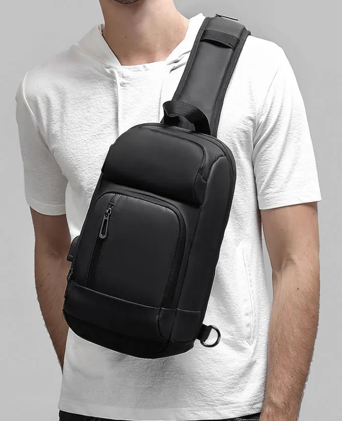 Black PVC outdoor shoulder bag with air cushion strap, soft handle, and laptop compartment