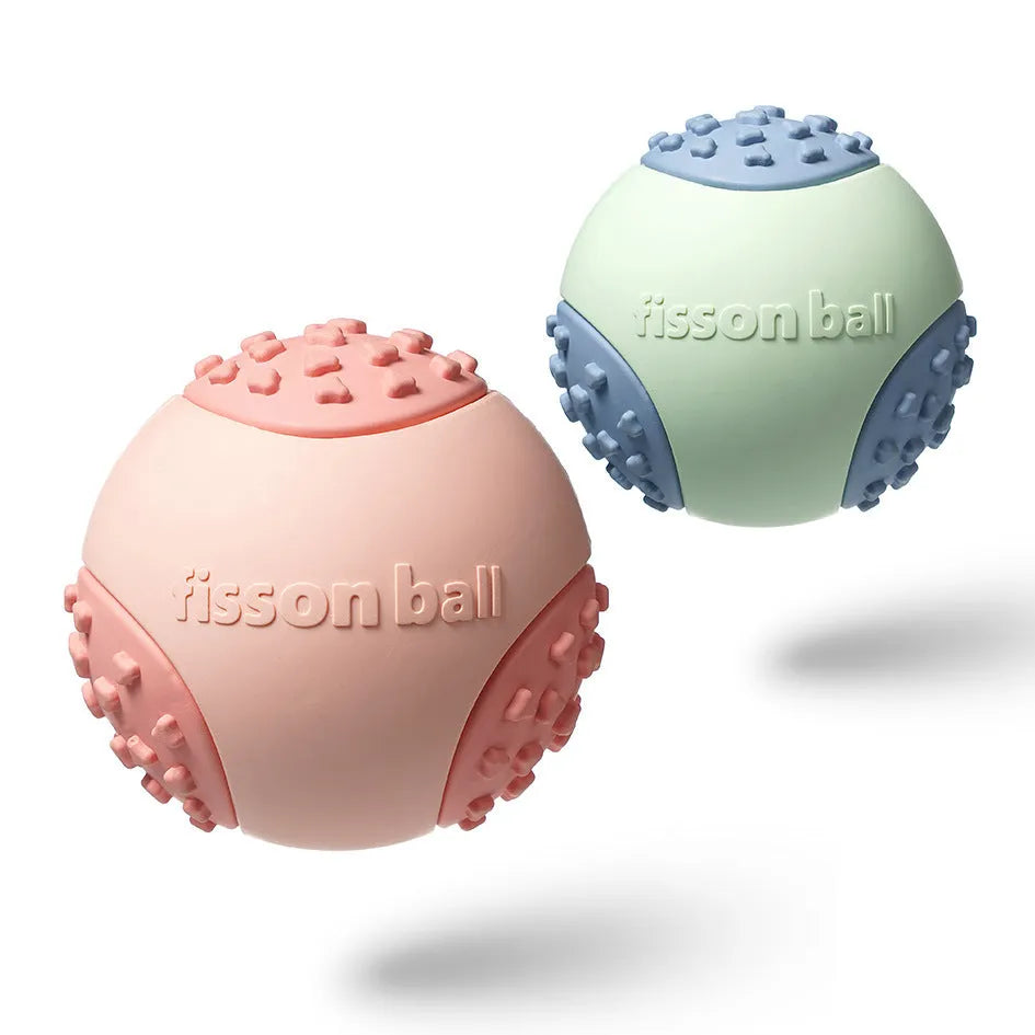 Green and pink rolling ball dog toy with 64mm diameter for interactive motion play