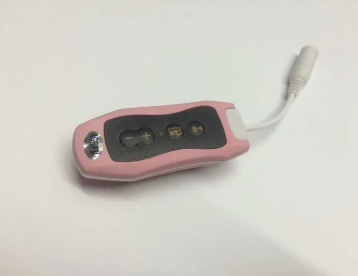 Compact black Bluetooth MP3 headset with USB cable, shown next to scale for size.
